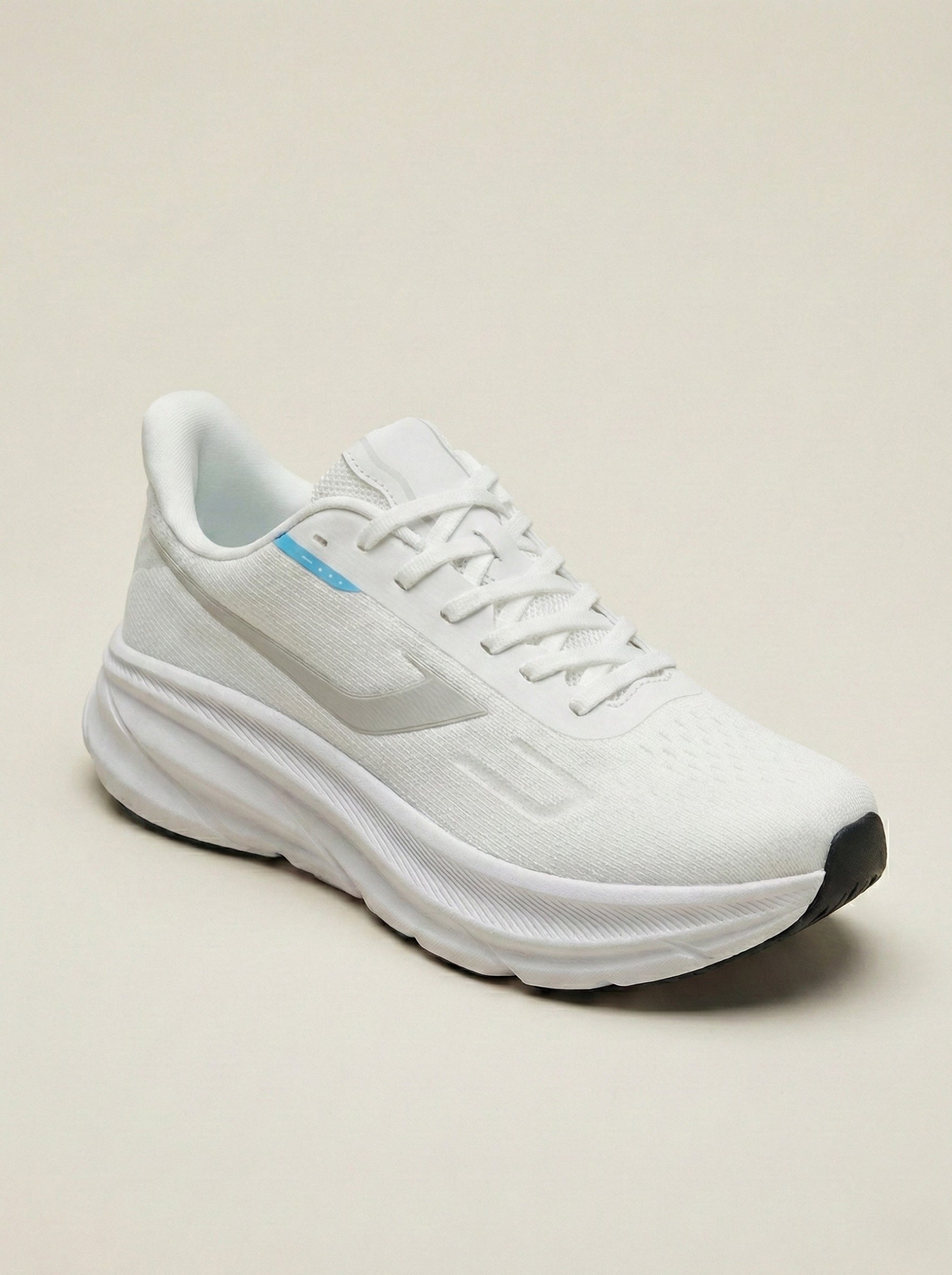 White running shoe on a beige background
