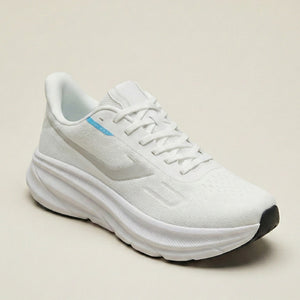 White running shoe on a beige background