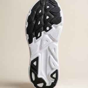 Close-up of a black and white athletic shoe sole on a beige background