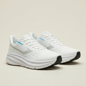 White running shoes with black soles on a light beige background