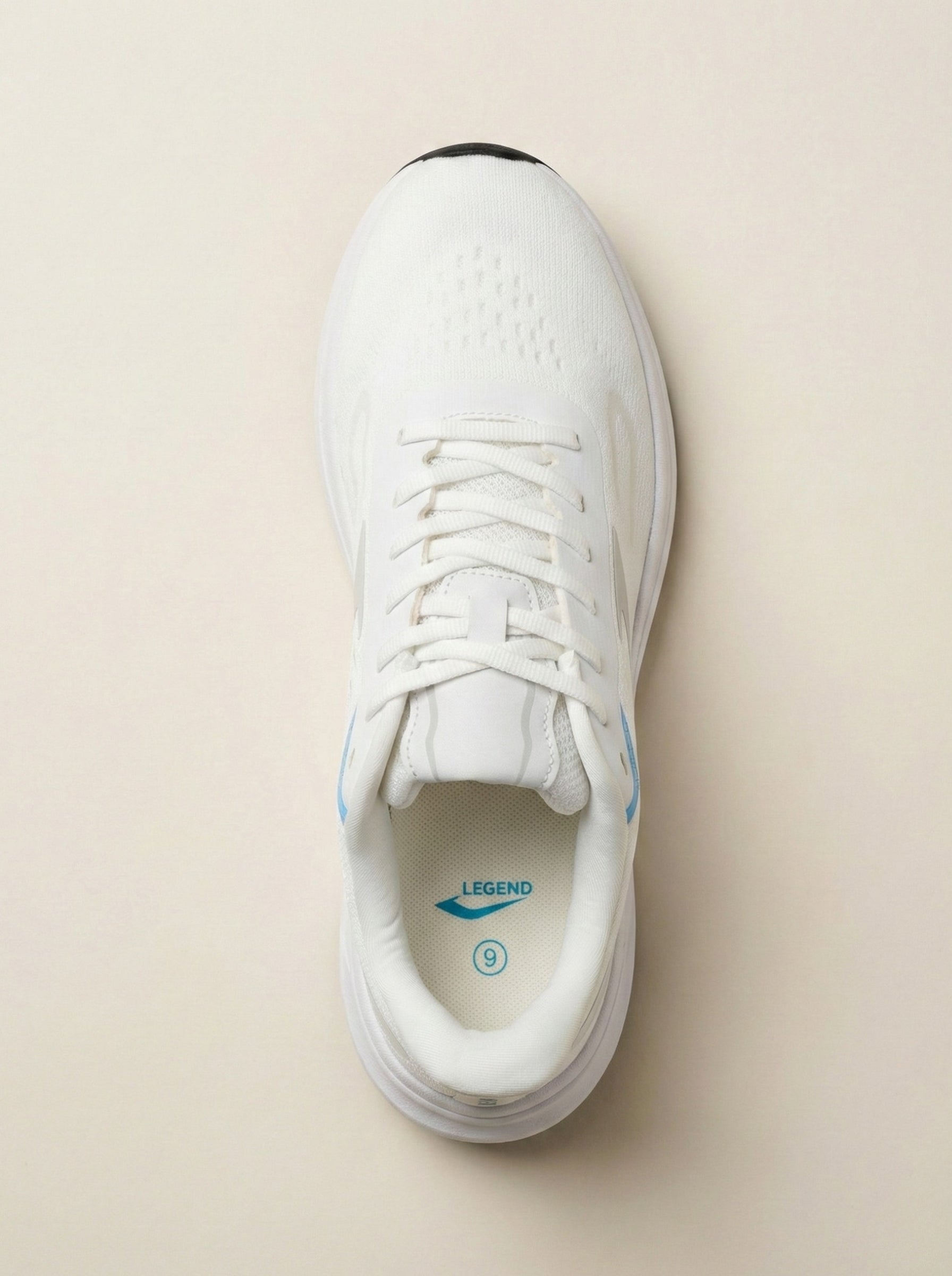 White sneaker with blue accents on a beige background