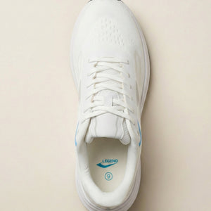 White sneaker with blue accents on a beige background